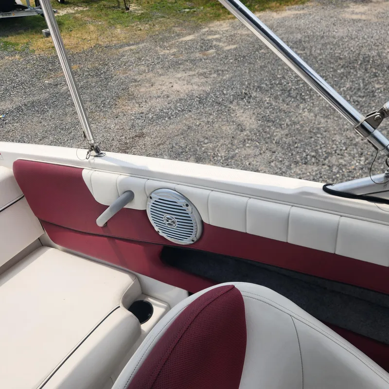 Slide: The Image of Interior of a 2018 Bayliner 185 Bowrider boat with red and white seating. - 20