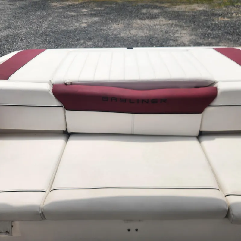 Slide: The Image of 2018 Bayliner 185 Bowrider boat with white and maroon seating. - 21