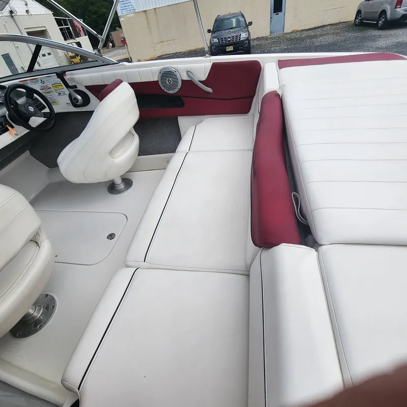 Slide: The Image of 2018 Bayliner 185 Bowrider interior with white and red seating. - 3