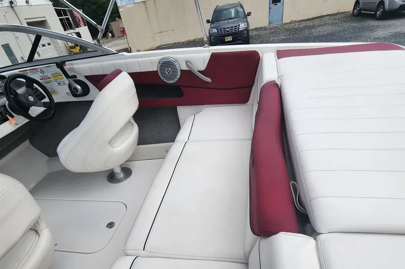 Slide: The Image of 2018 Bayliner 185 Bowrider interior with white and red seating. - 9