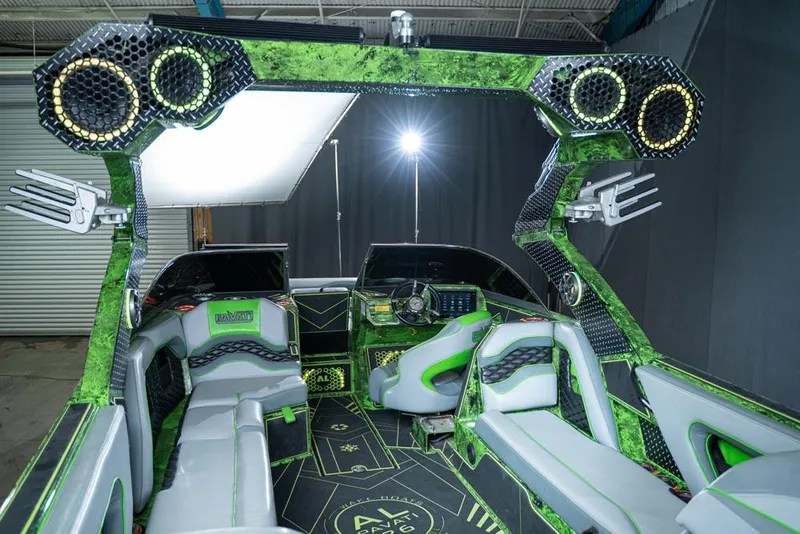Slide: The Image of 2018 Pavati AL26 boat interior with green and black accents, advanced sound system, and modern design. - 2