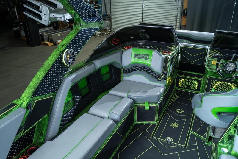 Slide: The Image of 2018 Pavati AL26 boat interior with green and black accents, luxurious seating, and modern design. - 3