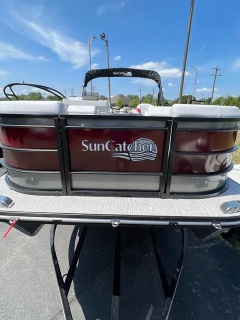 Slide: The Image of 2023 SunCatcher SELECT pontoon boat rear view on trailer. - 1