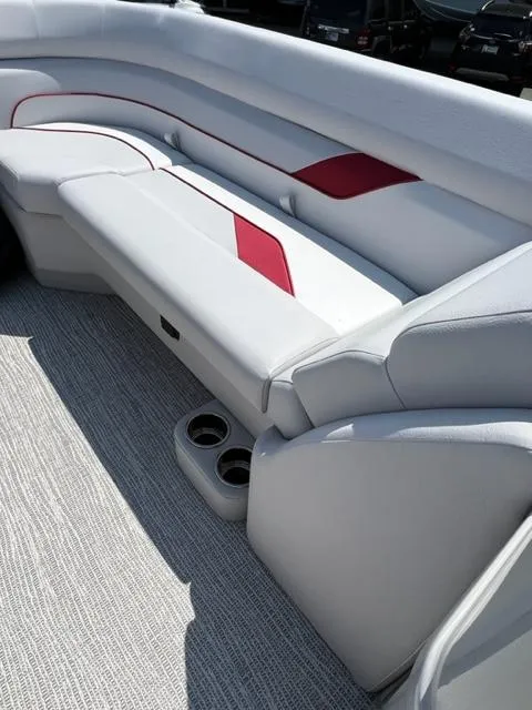 Slide: The Image of 2023 SunCatcher SELECT boat interior with white and red seating. - 10