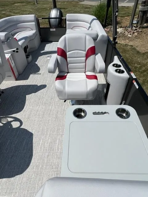 Slide: The Image of 2023 SunCatcher SELECT boat interior with white and red seating, cup holders, and table. - 11