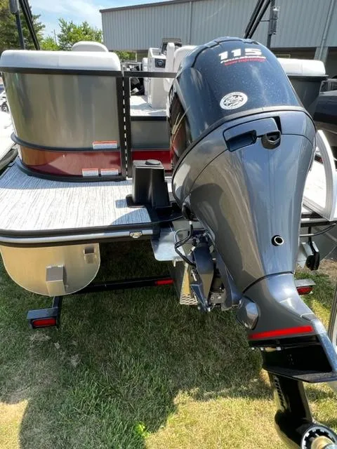 Slide: The Image of 2023 SunCatcher SELECT boat with powerful outboard motor, rear view. - 4