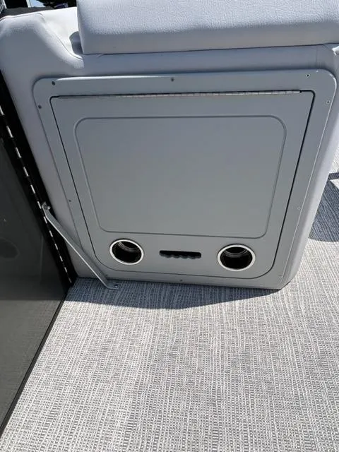 Slide: The Image of 2023 SunCatcher SELECT boat storage compartment with cup holders and cushioned seating. - 7