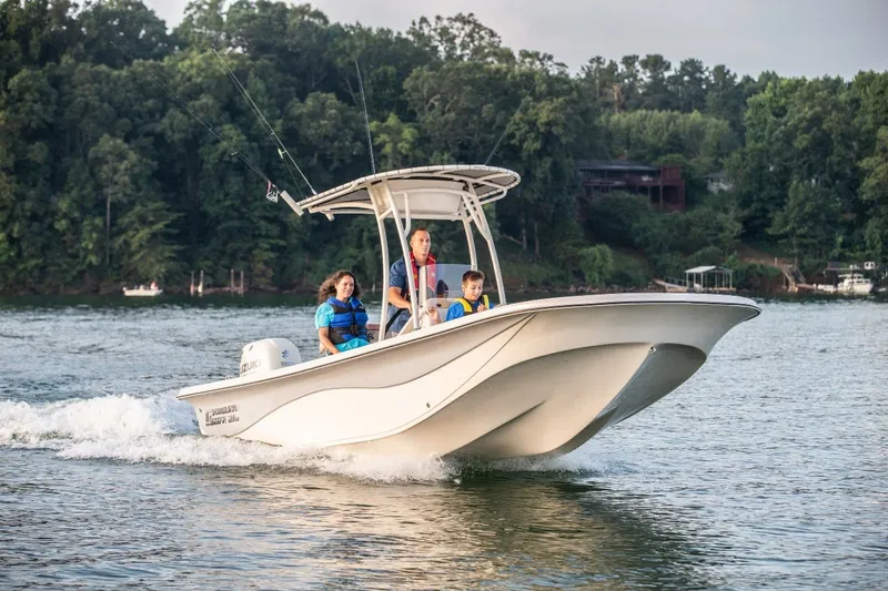 The Image of 2024 Carolina Skiff 21LS boat cruising on a lake with passengers. - 1