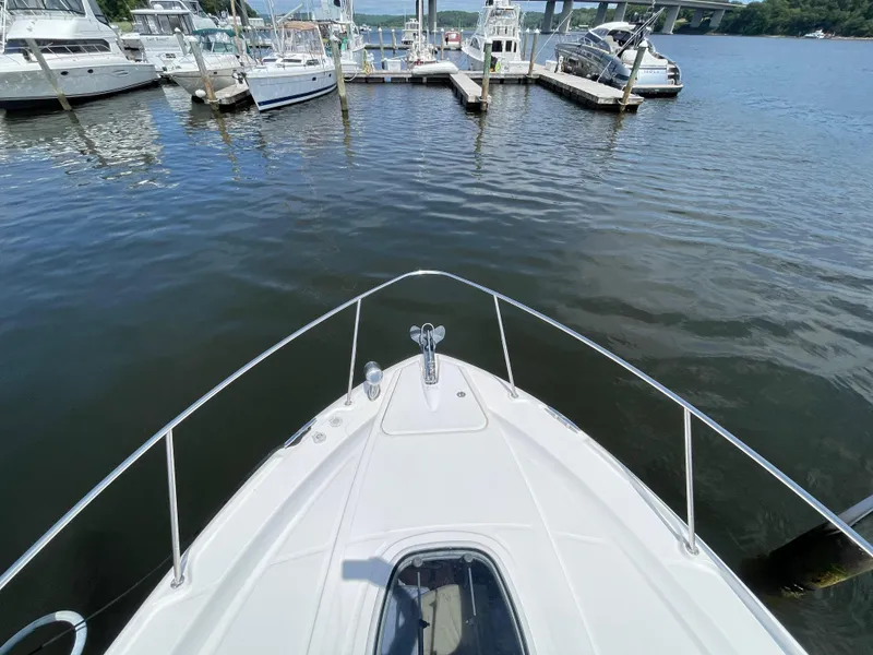 Slide: The Image of View from the bow of a 2012 Sea Ray 350 Sundancer at a marina. - 16