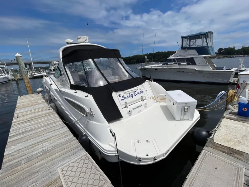 Slide: The Image of Sea Ray 350 Sundancer 2012 docked at marina with Lucky Break sign. - 2