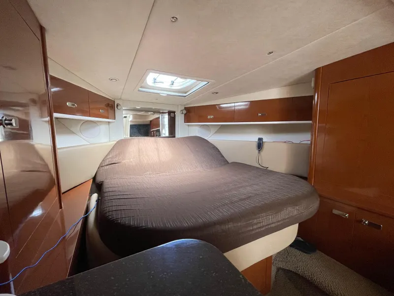 Slide: The Image of Interior cabin of a 2012 Sea Ray 350 Sundancer yacht with a cozy bed. - 20