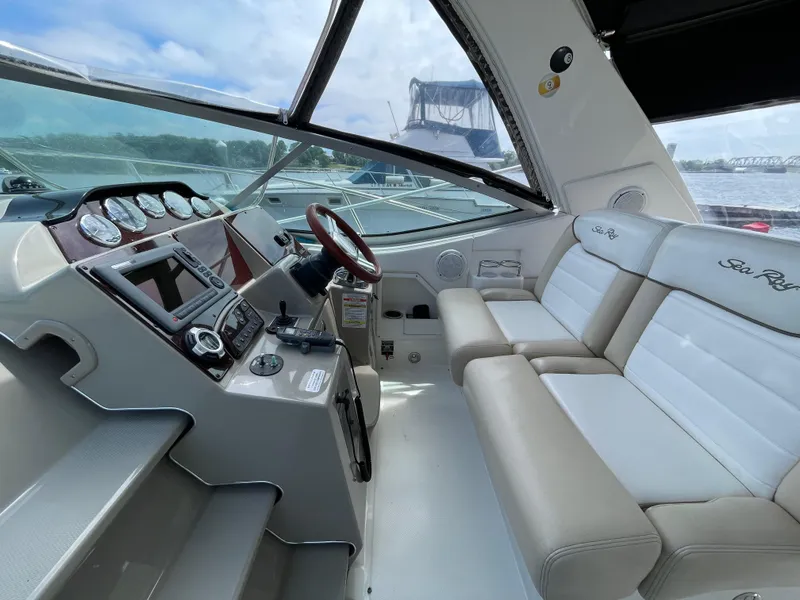Slide: The Image of Interior cockpit of a 2012 Sea Ray 350 Sundancer yacht with beige seating and control panel. - 3
