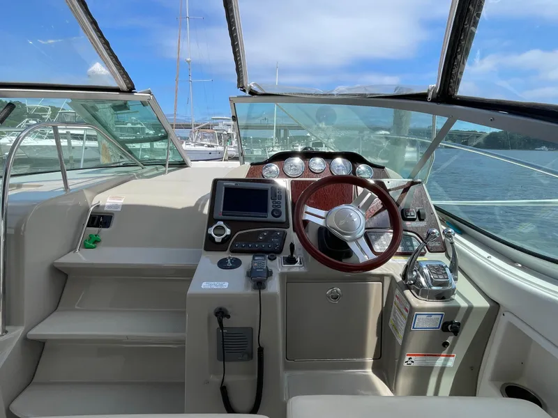 Slide: The Image of 2012 Sea Ray 350 Sundancer helm with navigation equipment and steering wheel. - 5
