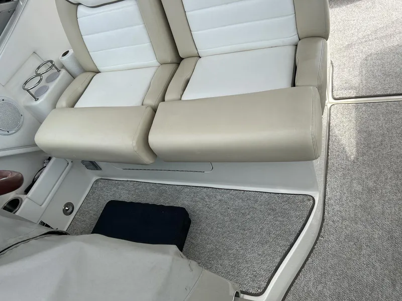 Slide: The Image of 2012 Sea Ray 350 Sundancer interior seating with beige and white upholstery. - 8
