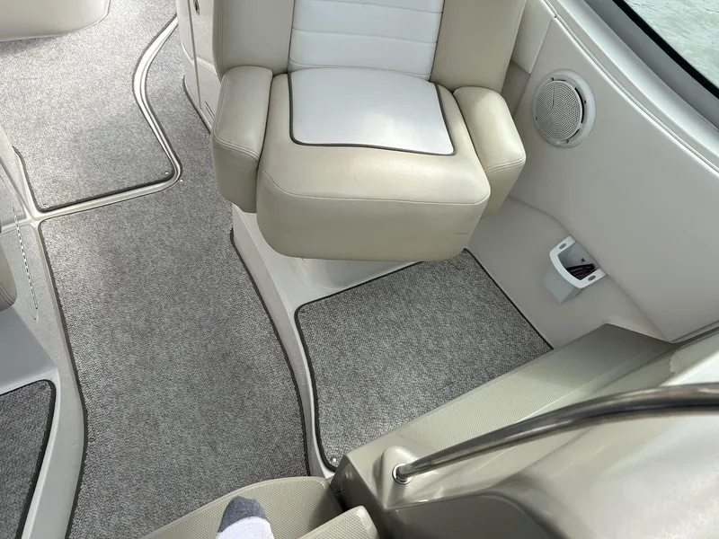 Slide: The Image of Interior of 2012 Sea Ray 350 Sundancer boat with beige seating and gray carpet. - 9