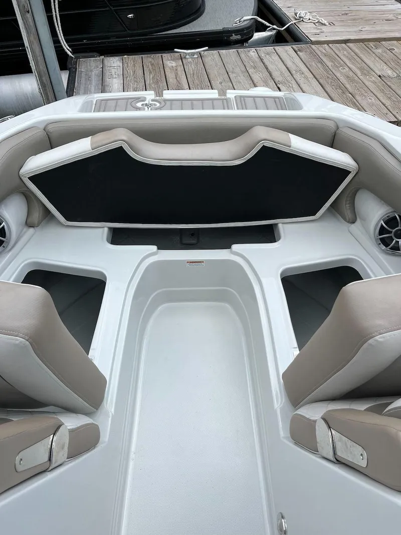 Slide: The Image of 2023 Crownline E 235 XS boat interior with seating and storage compartments. - 10