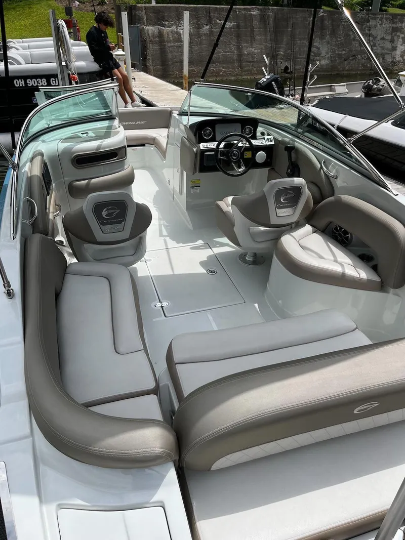 Slide: The Image of 2023 Crownline E 235 XS boat interior with seating and steering console. - 14