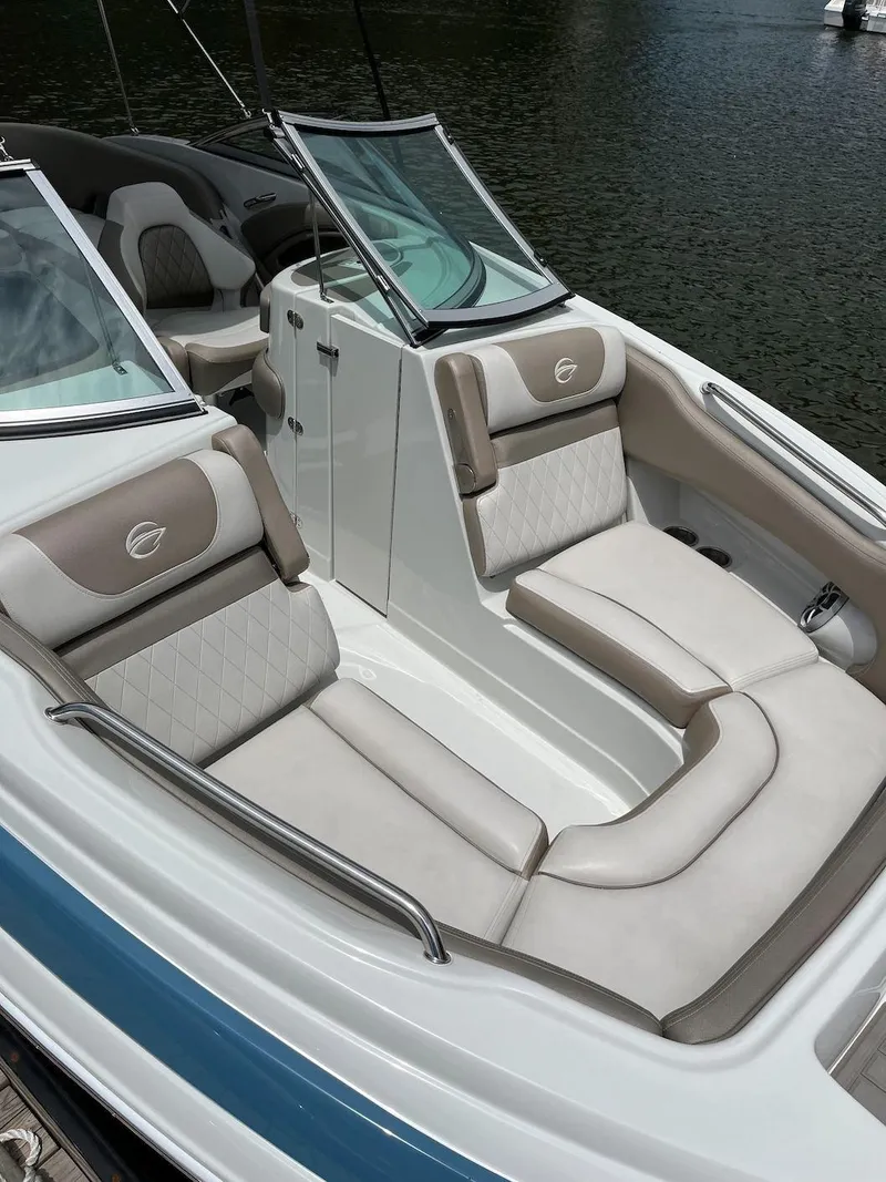 Slide: The Image of 2023 Crownline E 235 XS boat with luxurious seating and sleek design. - 2