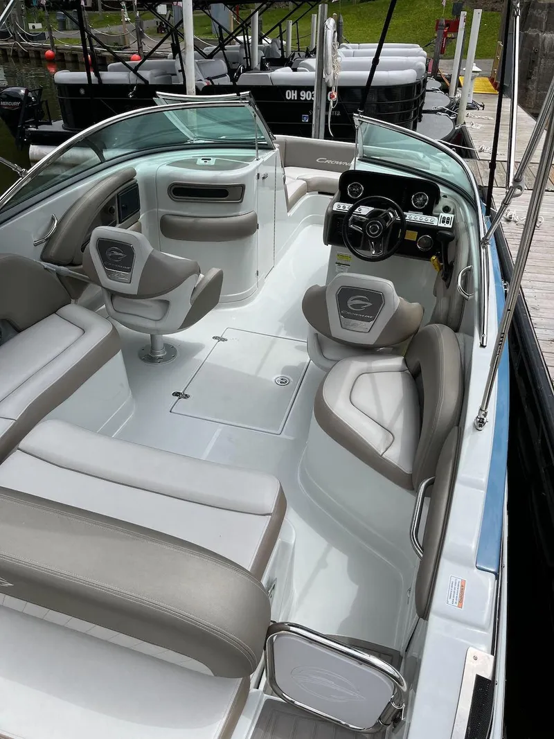 Slide: The Image of 2023 Crownline E 235 XS boat interior with seating and steering console. - 3