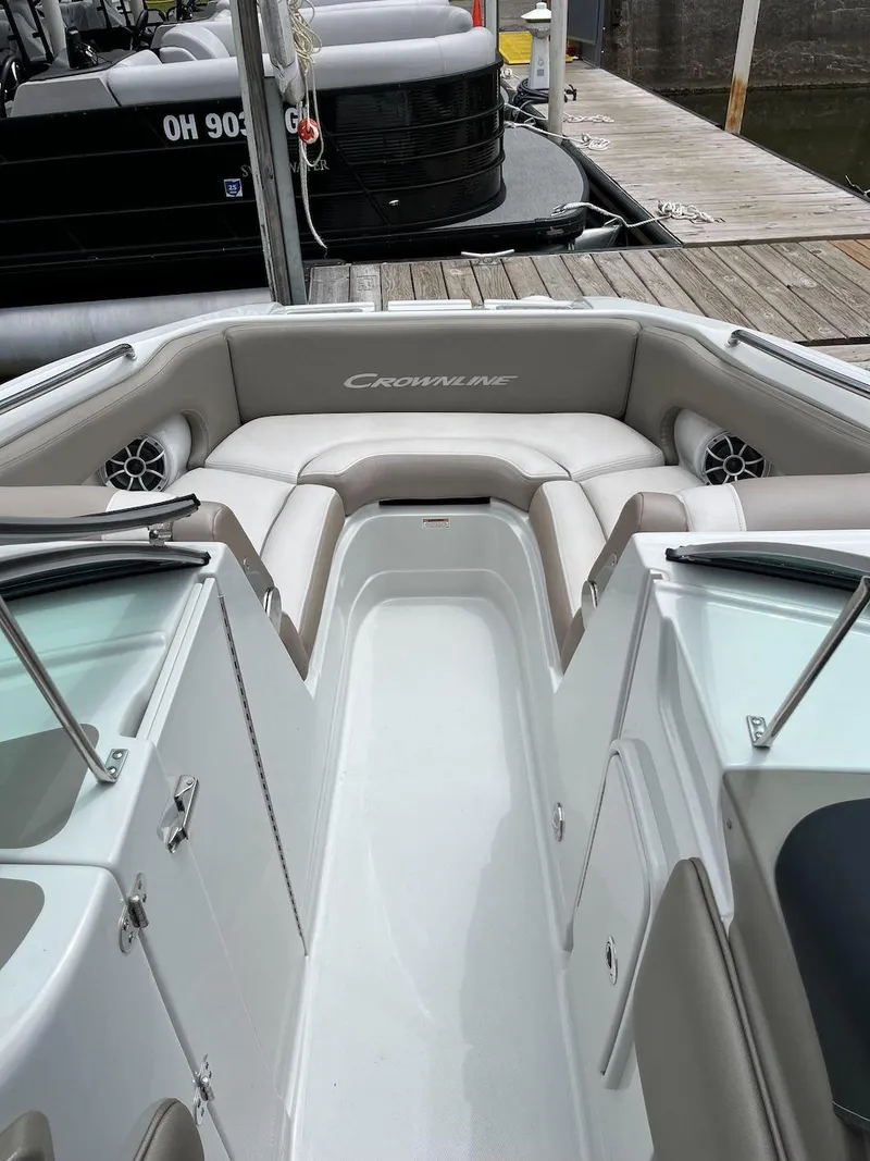 Slide: The Image of 2023 Crownline E 235 XS boat interior with seating and storage compartments. - 4