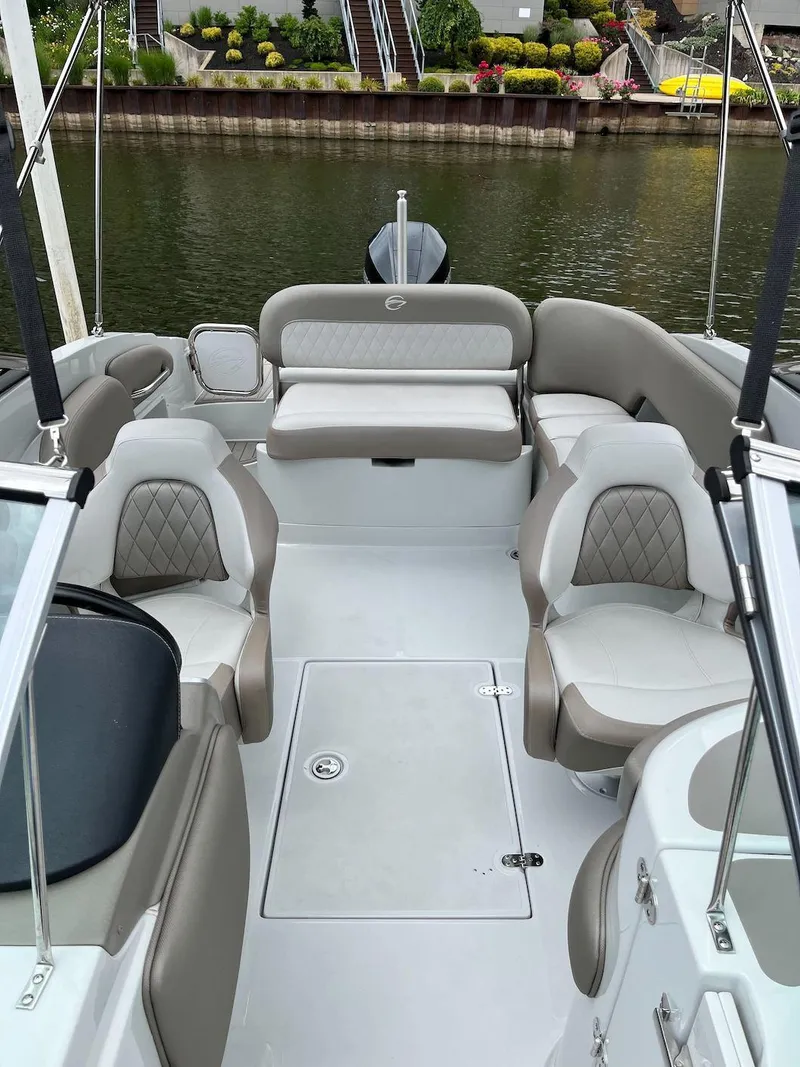 Slide: The Image of 2023 Crownline E 235 XS boat interior with luxurious seating and water view. - 5
