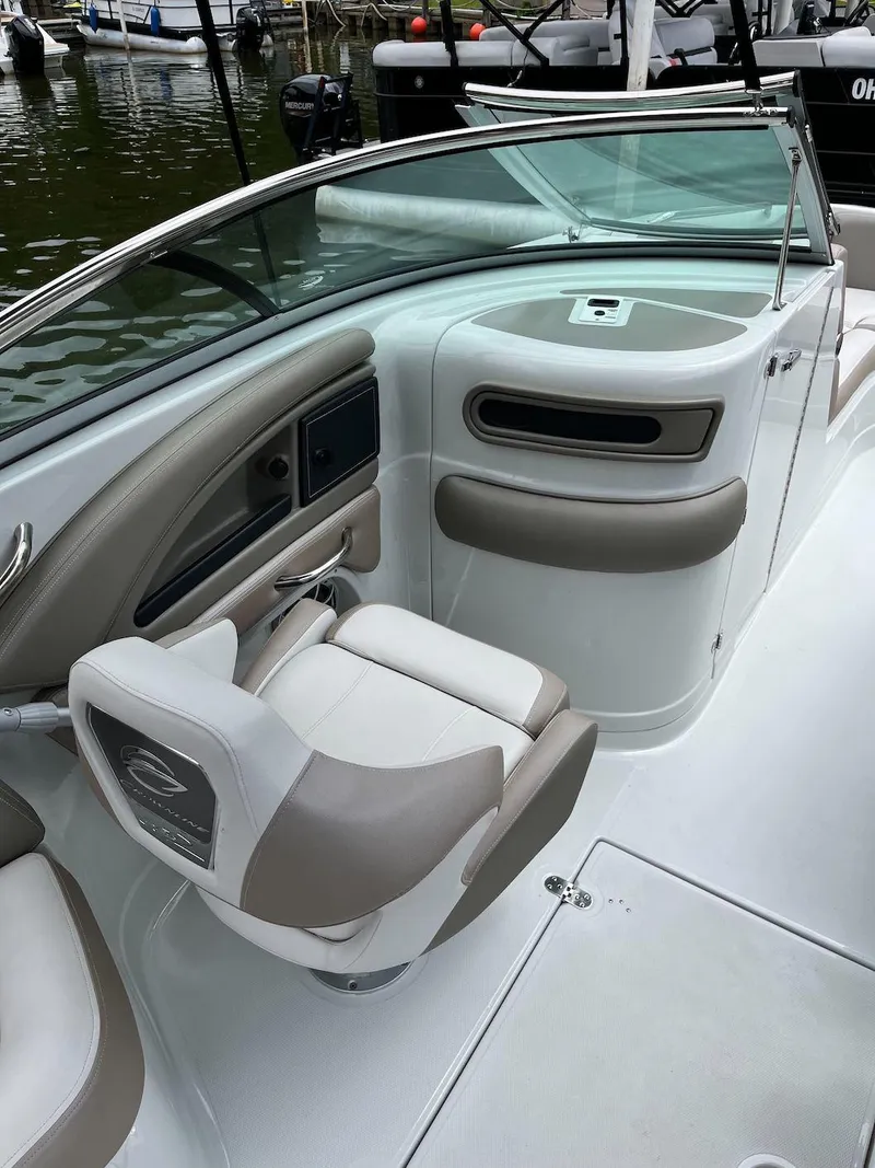 Slide: The Image of 2023 Crownline E 235 XS boat interior with beige and white seating. - 7