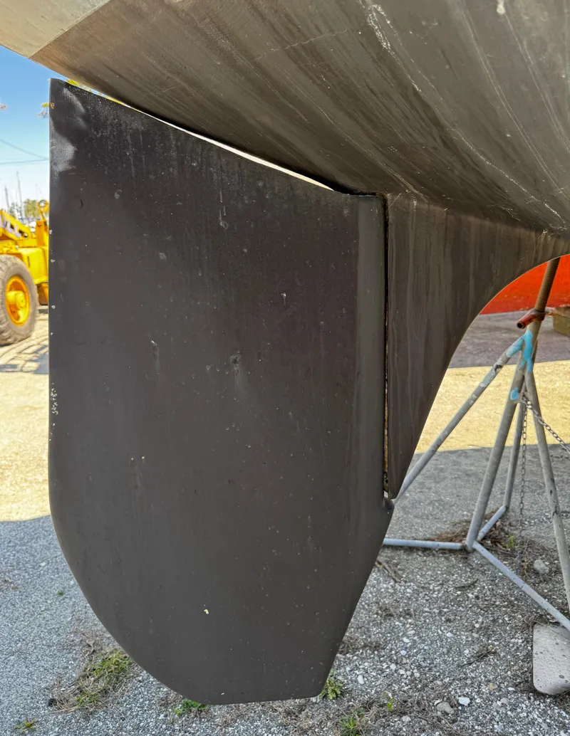 Slide: The Image of 1984 S2 9.2 sailboat keel on dry dock, supported by stands. - 13