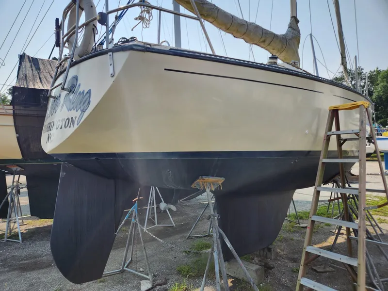 Slide: The Image of 1984 S2 9.2 sailboat on dry dock with ladder and support stands. - 4