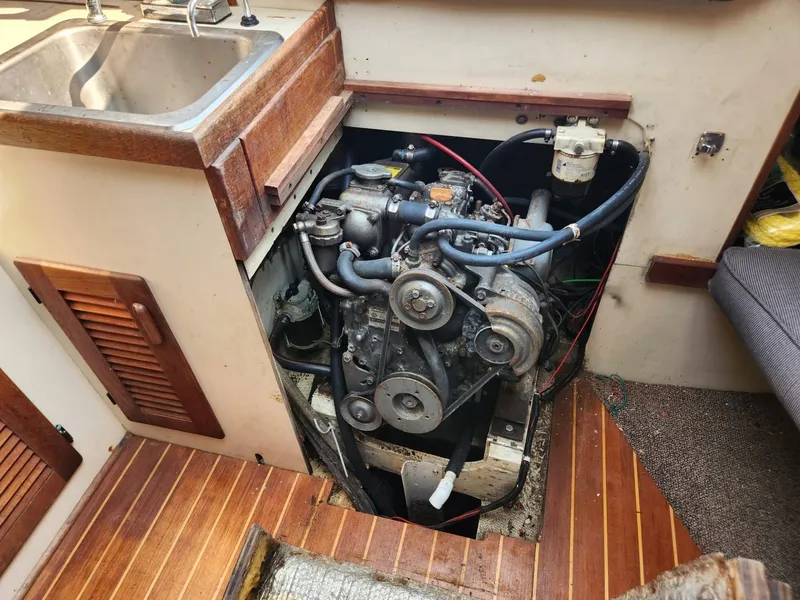 Slide: The Image of 1984 S2 9.2 boat engine compartment with visible engine and sink. - 43