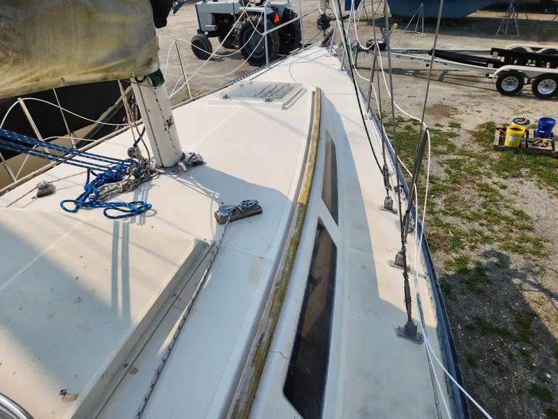Slide: The Image of 1984 S2 9.2 sailboat deck with rigging and windows in a boatyard. - 9