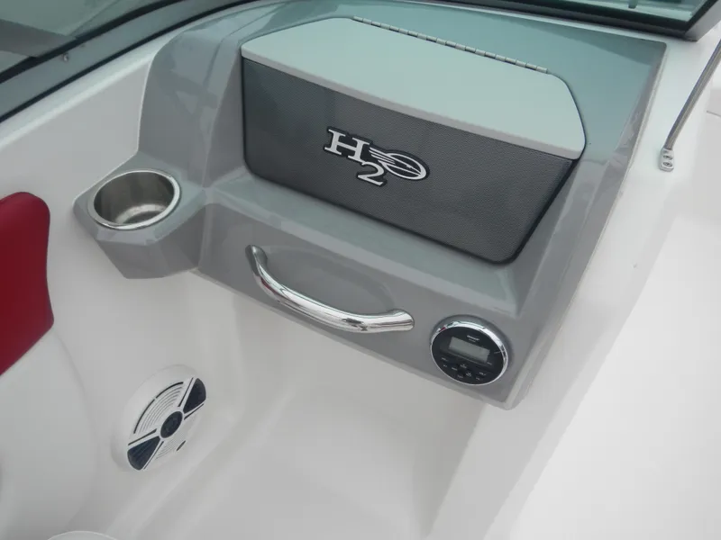 Slide: The Image of 2012 Chaparral 19 H2O Sport boat interior dashboard with cup holder and speaker. - 10