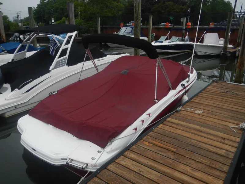 Slide: The Image of 2012 Chaparral 19 H2O Sport boat with red cover docked at marina. - 3
