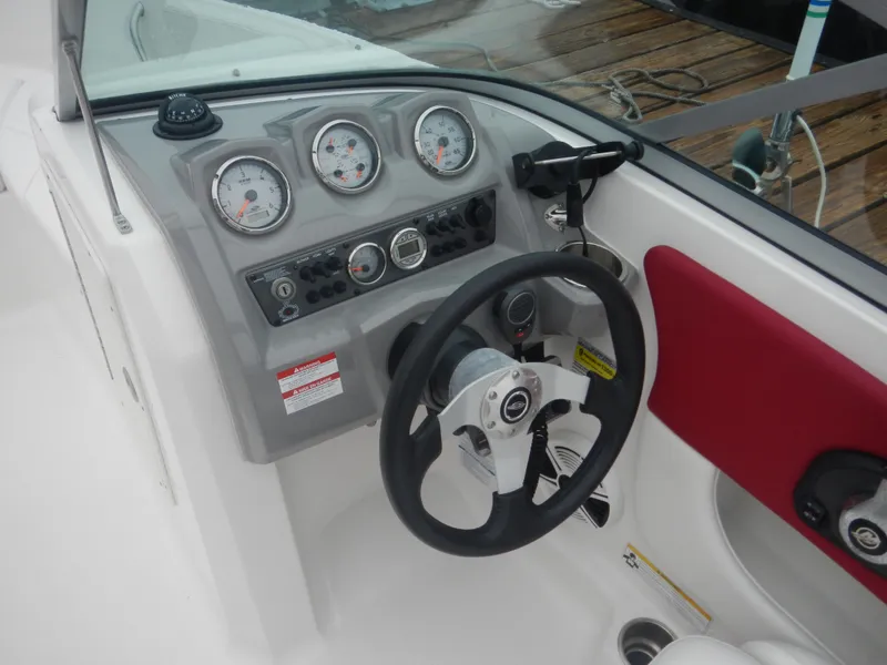 Slide: The Image of 2012 Chaparral 19 H2O Sport boat dashboard with steering wheel and gauges. - 7