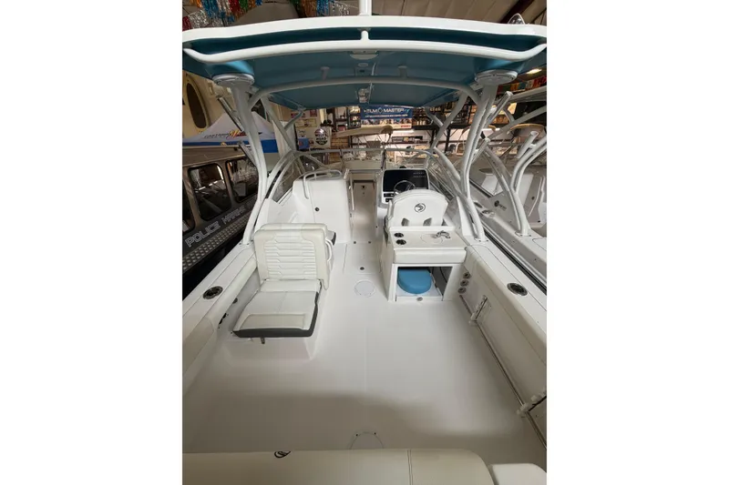 Slide: The Image of 2024 Edgewater 248CX Crossover boat interior with seating and helm station. - 12