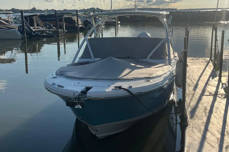 Slide: The Image of 2024 Edgewater 248CX boat docked at marina, covered and ready for use. - 8