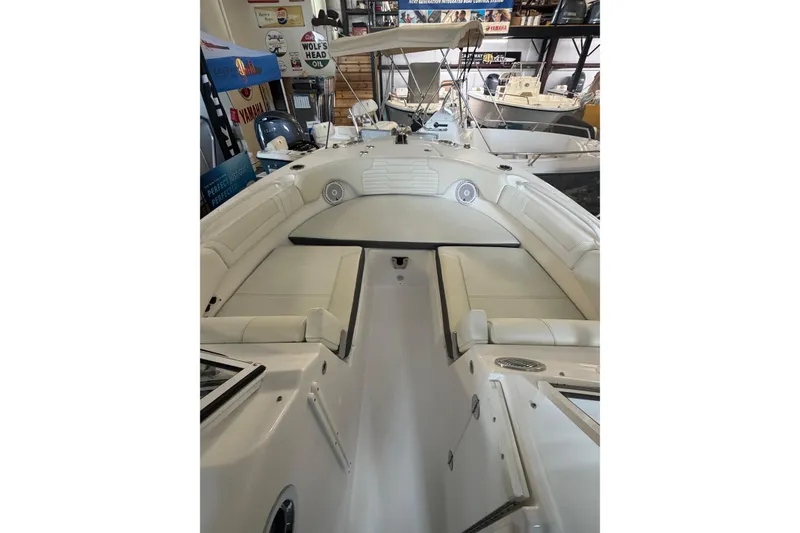 Slide: The Image of 2024 Edgewater 248CX Crossover boat interior with white seating and modern design. - 9