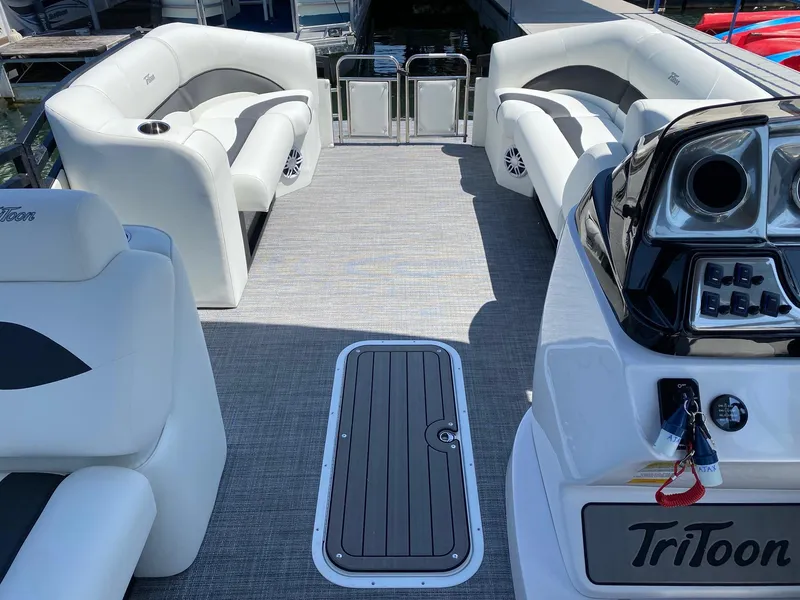 Slide: The Image of 2024 JC NEPTOON SPORT 21TT pontoon boat interior with white seating and modern dashboard. - 11