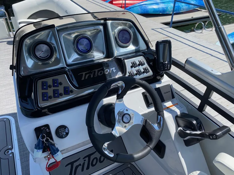 Slide: The Image of 2024 JC NEPTOON SPORT 21TT boat dashboard with steering wheel and control panel. - 15