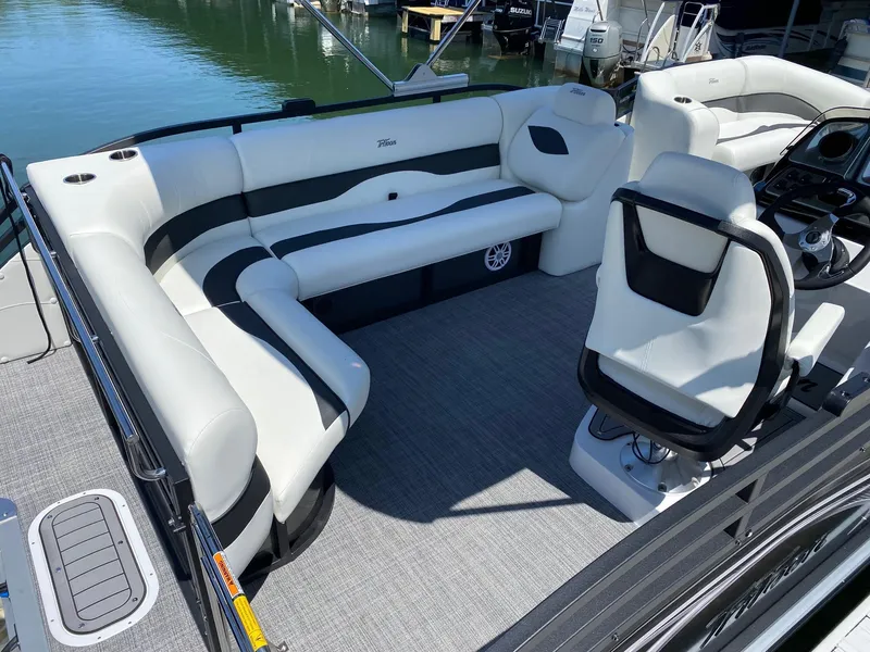 Slide: The Image of 2024 JC NEPTOON SPORT 21TT boat interior with white and black seating. - 19
