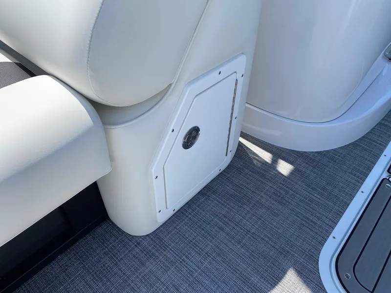 Slide: The Image of 2024 JC NEPTOON SPORT 21TT boat interior with storage compartment and cushioned seating. - 6