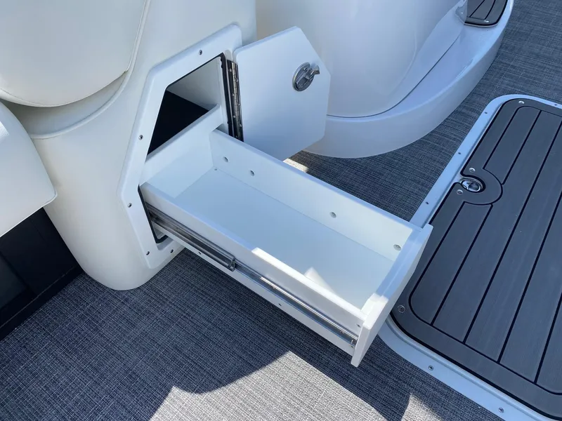 Slide: The Image of 2024 JC NEPTOON SPORT 21TT boat storage compartment with open drawer. - 7