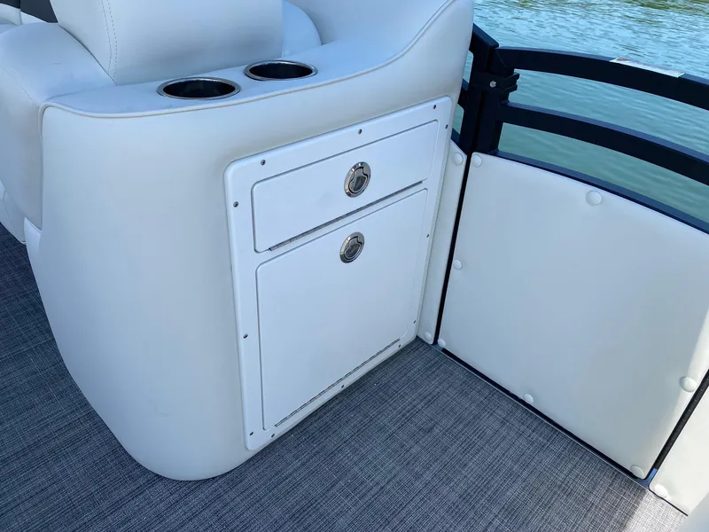 Slide: The Image of 2024 JC NEPTOON SPORT 21TT boat interior with storage compartment and cup holders. - 8