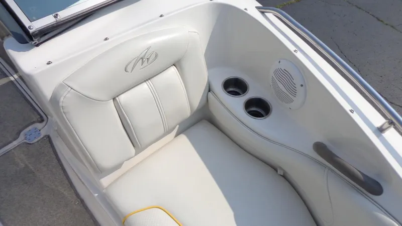 Slide: The Image of 2007 Monterey 214 FS boat interior with white cushioned seating and cup holders. - 11