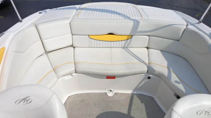 Slide: The Image of 2007 Monterey 214 FS boat with white and yellow cushioned seating. - 13