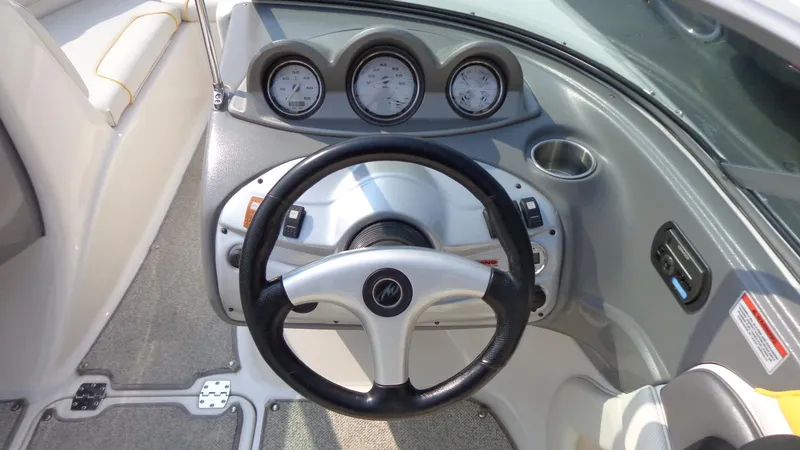 Slide: The Image of 2007 Monterey 214 FS boat dashboard with steering wheel and gauges. - 7