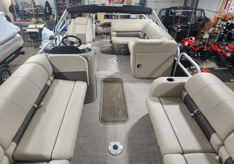 Slide: The Image of 2023 Sun Tracker SportFish 22 XP3 pontoon boat interior with beige seating. - 2