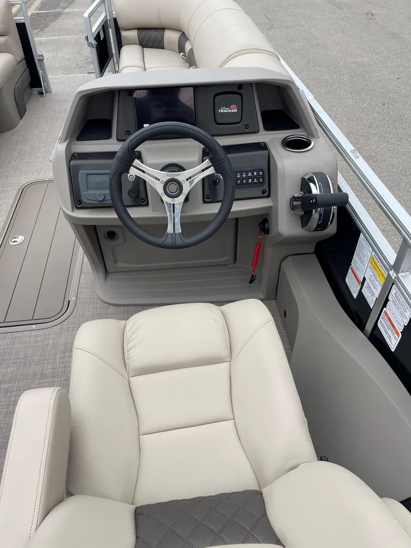 Slide: The Image of 2023 Sun Tracker SportFish 22 XP3 boat interior with steering wheel and seating. - 4