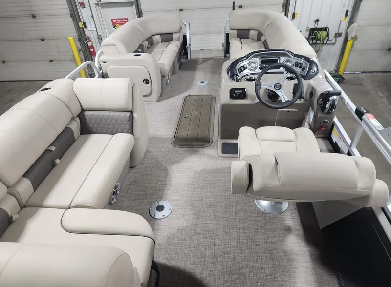 Slide: The Image of 2023 Sun Tracker SportFish 22 XP3 interior with beige seating and modern dashboard. - 5