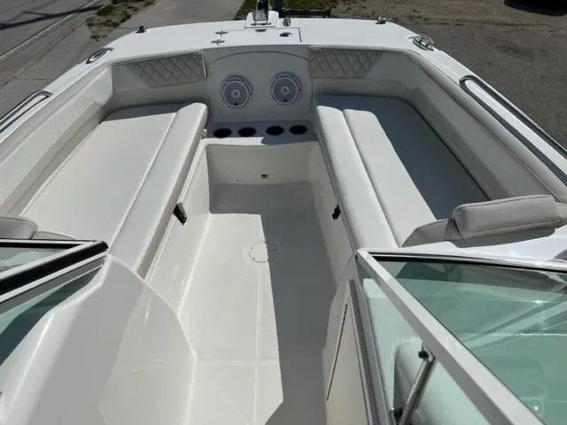 Slide: The Image of 2023 World Cat 230 DC boat interior with white seating and cup holders. - 5