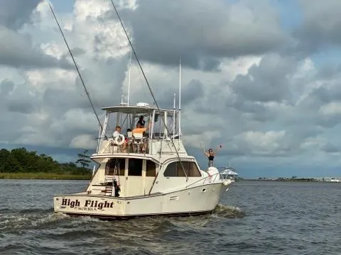 Slide: The Image of 1984 Post Sportfish boat High Flight cruising on a cloudy day. - 0